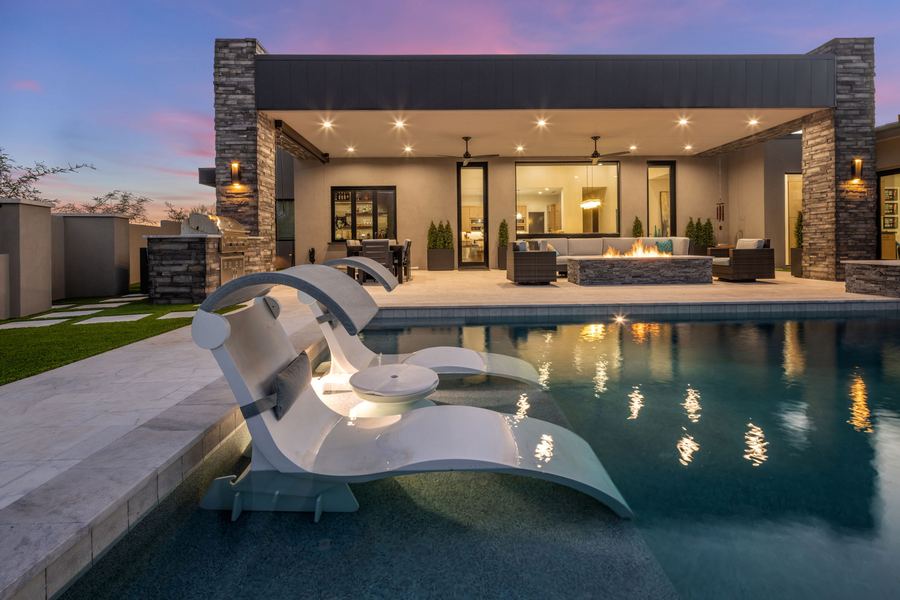 Pool with in-water loungers at dusk in Gold Canyon, AZ