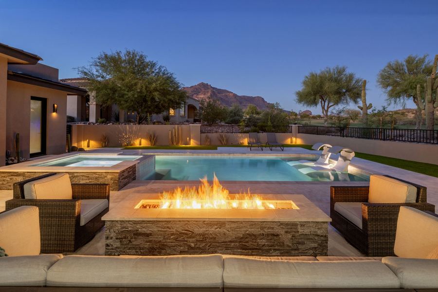 Linear fire table facing a pool and spa with mountain views in Gold Canyon, AZ